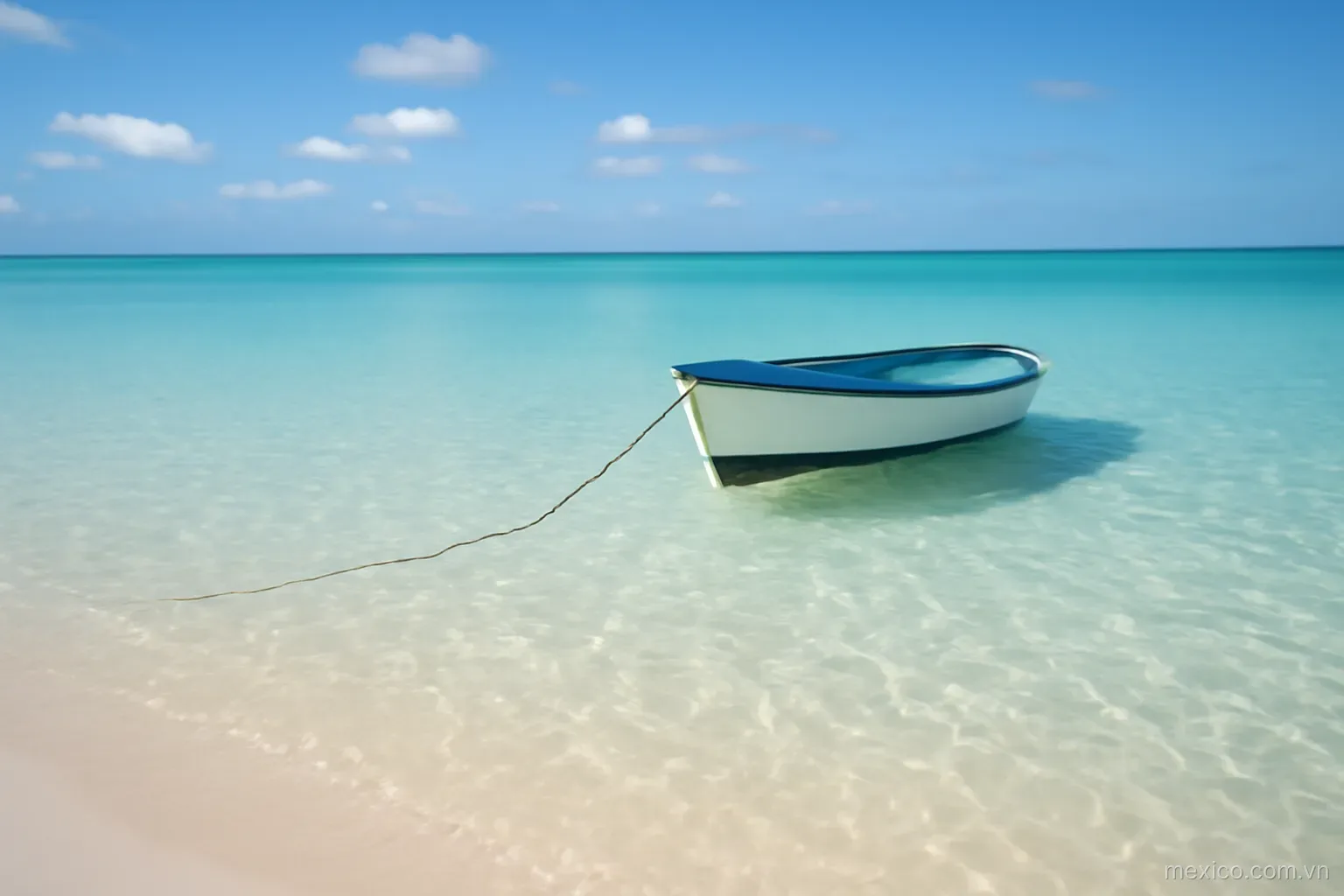 Clear shallow water over pale sand with a small boat anchored, wide view, no text