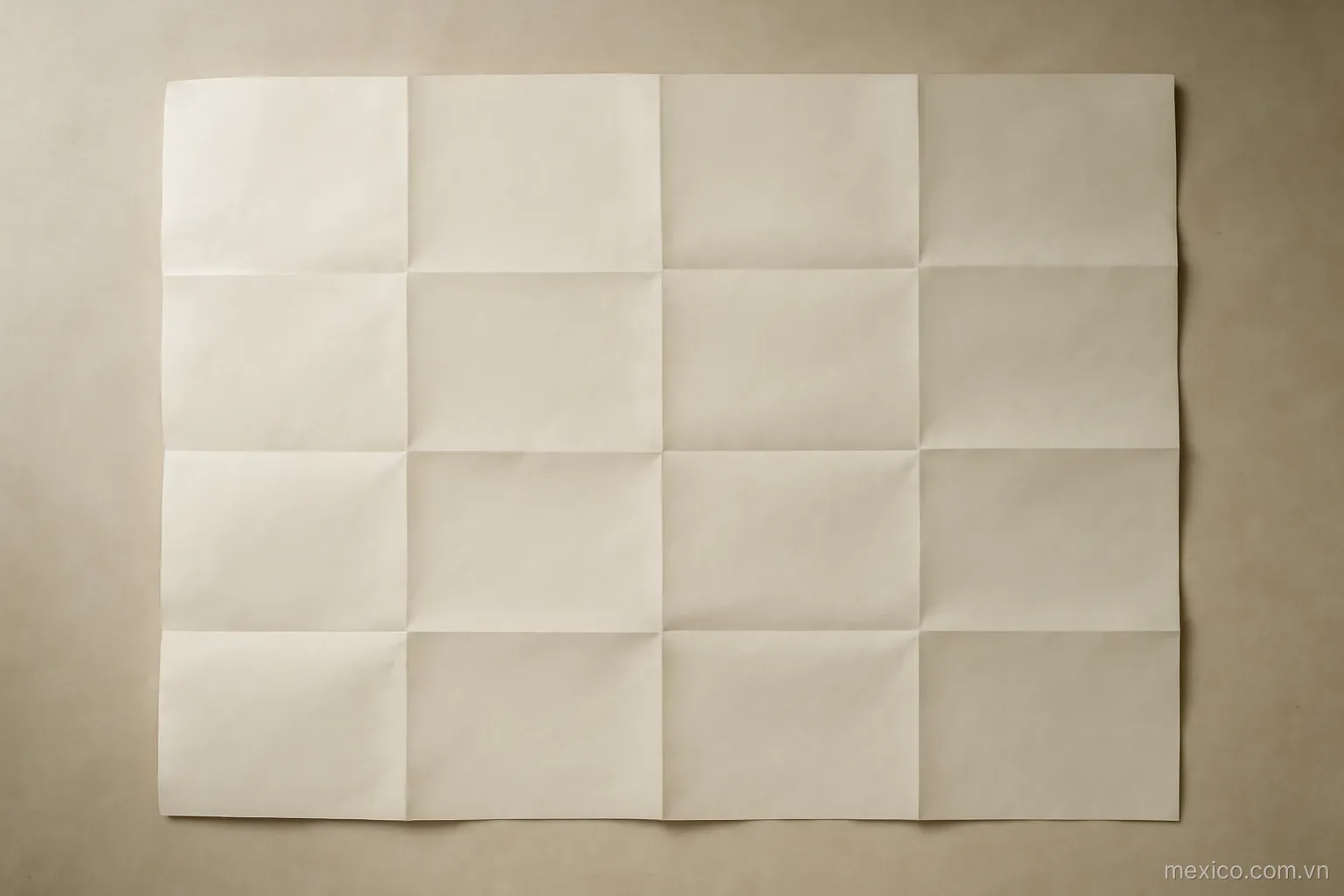 An unfolded sheet of paper showing a full grid of creases with rectangles of many sizes, overhead view, no text