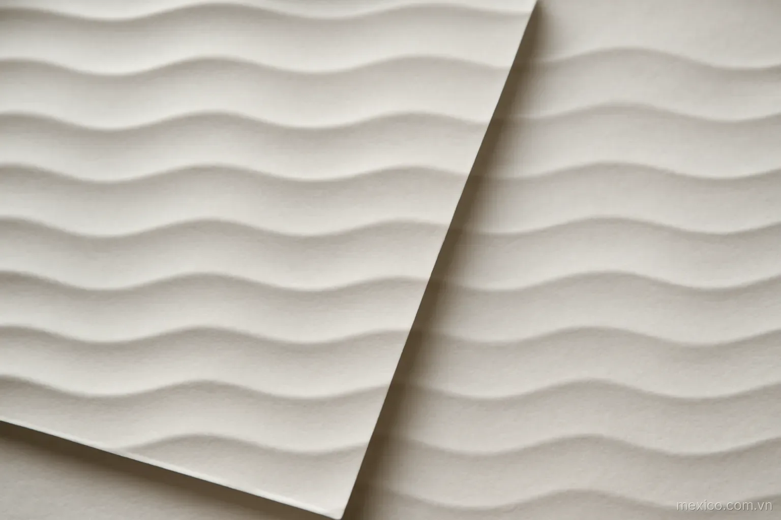 Two wave-like crease patterns overlapping on paper at different spacings, overhead view, no text
